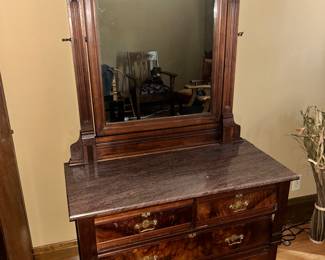 3 Chest of drawers with pivoting mirror and granite top.