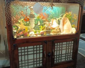 Very cool Asian fish tank made up as a terrarium. I think there should be a Barbie bed in there. She should be sleeping with the fishes.