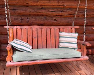 One of two wood/log porch swings