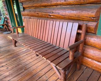 One of two long wood/log benches