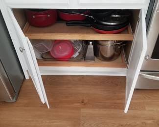 Kitchen cabinets have pull out shelves