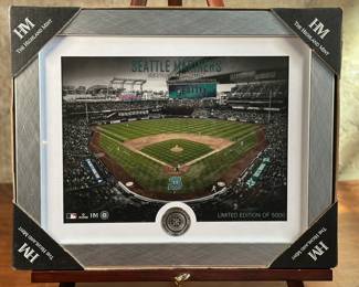 This lot features a like-new, limited edition Seattle Mariners Art Deco Silver Coin Photo by Highland Mint. This item from Highland Mint measures in the frame, 12” H x 15” W. The Highland Mint, a full-service mint, was established in the early 1980s and is located in Melbourne, Florida. They are known for producing a wide variety of products, including Super Bowl flip coins, sports memorabilia, and silver rounds. The company is officially licensed by major sports leagues like the NFL, MLB, and NBA, as well as other organizations.