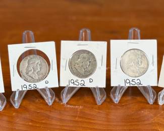 This lot features five (5) silver Franklin half dollars from 1952, kept in protective slips. 90% silver. The Franklin Half Dollar is a silver coin minted by the United States Mint from 1948 to 1963. It features Benjamin Franklin on the obverse and the Liberty Bell on the reverse. The coin was designed by John R. Sinnock, with some design elements added by Gilroy Roberts after Sinnock’s death. The Franklin Half Dollar marked the end of the “golden age of American coinage art” and the shift from allegorical figures to historical figures on coins.