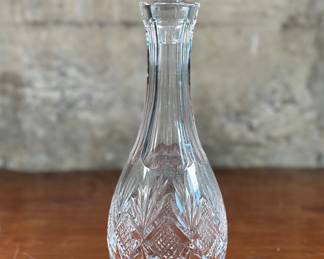 This lot features an Irish Waterford crystal decanter. This Irish Waterford crystal decanter measures, 11.25” H x 4” W x 4” D. Waterford Crystal is prized for its exceptional craftsmanship, brilliant clarity, and intricate designs, passed down through generations of skilled artisans. The brand’s legacy of creating luxury glassware, barware, and homeware of unrivaled quality has earned it a reputation for excellence.