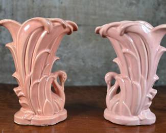 This lot features a pair of McCoy swan vases, circa 1930s. A matching pair with maker mark underneath as shown in photos. Both are in good overall condition. Each vase measures, 9” H x 4.25” W x 7” D. McCoy Pottery, established in 1899 by James W. McCoy, evolved from a family-run business to a major player in the American pottery industry, ultimately closing in 1990. The company, known for its functional stoneware and later art pottery, experienced several ownership changes and name alterations, including the Nelson McCoy Pottery Co. in 1933. Key milestones include the merger with Brush Pottery in 1911, forming Brush-McCoy Pottery. The company also faced challenges, including a major fire in 1950. Despite changing hands and facing economic shifts, McCoy Pottery remained a popular and recognizable name for its quality and unique designs, particularly its art pottery lines.