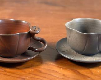 This lot features a pair of beautiful studio pottery teacups and saucers by unknown artist. Both are in very good condition.