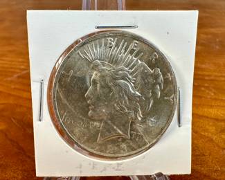 This lot features a 1923 Peace Dollar. The Peace dollar, a US silver dollar coin, was minted to commemorate the end of World War I and to symbolize the country’s hope for lasting peace. It was designed by Anthony de Francisci and was struck in 1921 and 1922 in high relief before being switched to a lower relief design in 1922. The coin was first minted in 1921 and continued to be produced until 1928, and then again in 1934 and 1935.