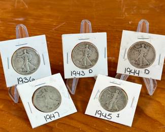 This lot features five (5) Walking Liberty Half Dollars from various years including 1936, 1943, 1944, 1945, and 1947. The Walking Liberty Half Dollar is a silver 50-cent coin issued by the US Mint from 1916 to 1947. Designed by Adolph Weinman, it features Lady Liberty walking towards the rising sun, a design considered iconic and beautiful. These coins were minted at the Philadelphia, Denver, and San Francisco mints.