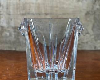 This lot features a vintage Lenox Ovations lead crystal ice bucket in very good condition. This Lenox Ovations ice bucket measures, 7.5” H x 8” W x 6.5” D. Lenox Crystal Company’s history spans over a century, starting with Walter Scott Lenox’s vision to create high-quality American-made china and crystal. Initially known for fine china, the company expanded to include crystal and other tableware. Lenox became a global competitor, even being the first American china used at the White House.