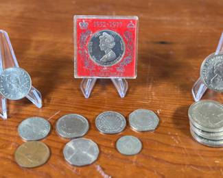 This lot features various silver coins and more. Many have been kept in protective cases and are in good condition. Silver content unknown.
