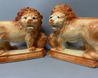 Pair of Staffordshire lion figurines with balls