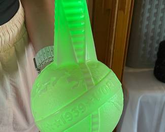 CLOSE UP OF URANIUM GLASS WORLDS FAIR VINEGAR BOTTLE