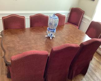 Dining room table and 8 chairs with red cover and 2 leaves
