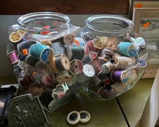 Vintage fish bowls filled with thread