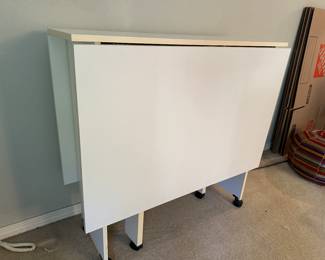 White folding table - large enough to seat 6 but folds up well to save space - and on wheels to move easily.