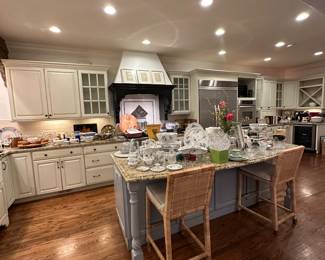 Serena and Lilly bar stools, full kitchen featuring brands like Le Creuset, Sur La Table, Ralph Lauren, Limoges, Twos Company, and Mexican Art glas
