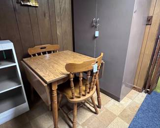 Drop leaf table, two chairs, metal cabinet