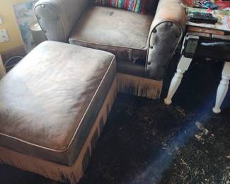 Custom made Swivel Rocker armchair and matching Ottoman. Both pieces have leather fringe around bottom