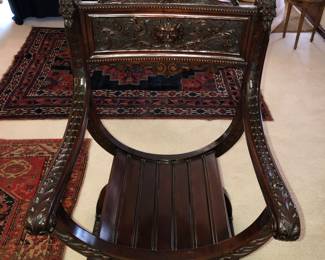 Antique carved Savonarola chair with Northwind face 