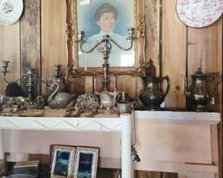 Antique mantle, portrait, and silver pieces.