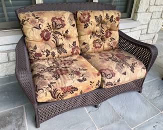 Lloyd Flanders loveseat with upholstered cushions