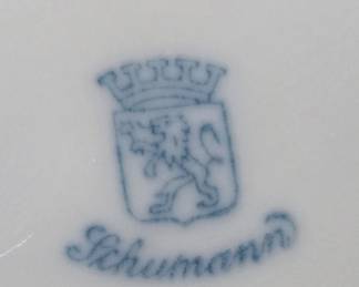 Schumann mark on a flowered, gold-trimmed bowl.