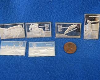 Lot 316. Six 1980 sterling silver Olympic bars shaped as stamps. 71 grams total.