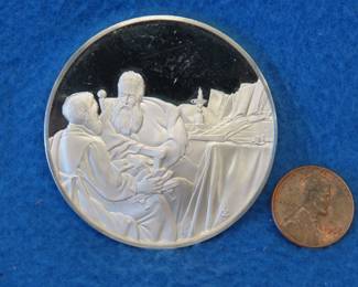 Lot 319. Franklin Mint sterling silver coin "Two Scholars Disputing" by Rembrandt. 65.71 grams.