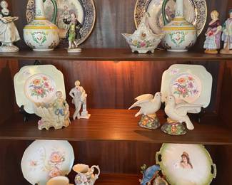 Contents of bookcase including French porcelain sewers, occupied Japan figurines and other items