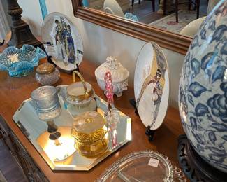 Dresser adorned with Fenton and vintage powder jars