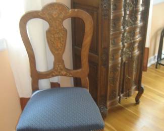 Chair with inlay detail, ornate antique music cabinet, blue glass vase