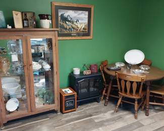 curio cabinet, rustic cabinet, dining table and chairs, “wood stove” electric heater, infrared heater