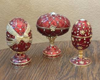 Lot #15 - Set of Three Red Enamel Reproduction Faberge Egg Musical Jewelry Boxes