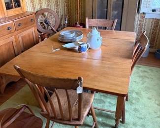 Three plus one in corner chairs that match two in previous photo. Drop leaf table that would seat six. The cupboard to left of table is NOT FOR SALE. Vintage picnic basket