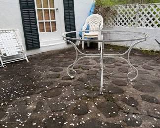 Large vintage round table. Glass top in garage.