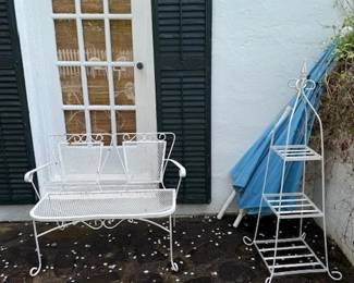 Vintage two seat iron bench.
Three tiered plant stand. Blue umbrella goes with table in another photo.