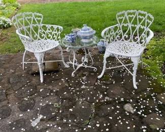 Pair of later iron chairs. Vintage table with glass top.