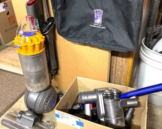 Dyson Swivel ball upright vacuum and a complete Dyson handheld vacuum with accessories.