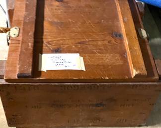 Vintage military ammunition box with rope handles and latches.