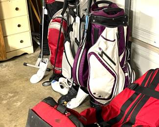 Golf bsgs, clubs and two travel cases.