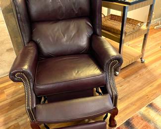 Leather push back recliner with hobnail accents.