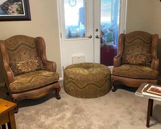 Custom chairs with leather, hobnail, and wood accents. Large, upholstered ottoman.