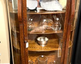 Antique curved glass curio cabinet.