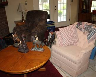 pink swivel rocker and round oak coffee table