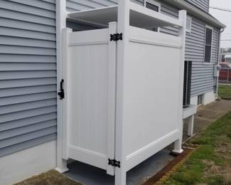 Vinyl outdoor shower surround is approximately 46" wide x 76" deep; has a roof