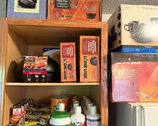 Canned goods, vitamins, tang, Pyrex set, dinnerware set, pfaltzgraff butter dish, lodge logic cast iron new in box sets