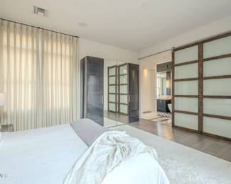 Wardrobes to match the bed and nightstands. Area rug.