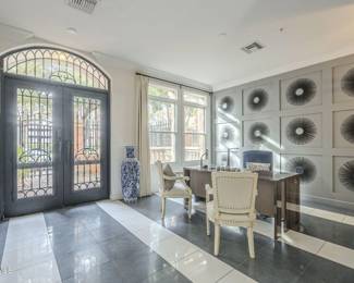 Armed dining chairs, asian vases, and a desk.