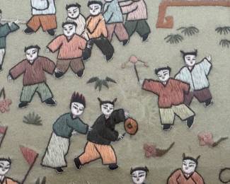 Close up detail of Chinese silk embroidery, framed under glass