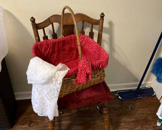 Laundry room - desk chair with red cushion, lined basket, and lace type table cloth